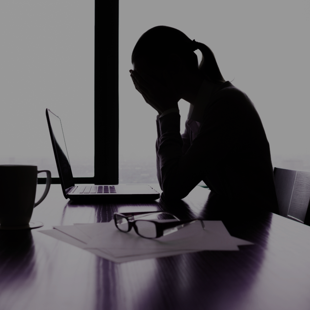 Woman holding head in stress, highlighting chronic stress impact on women's health.