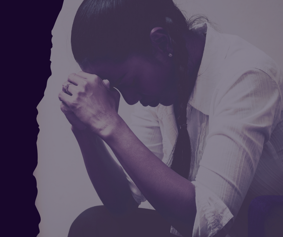 Woman holding head in stress, highlighting chronic stress impact on women's health.