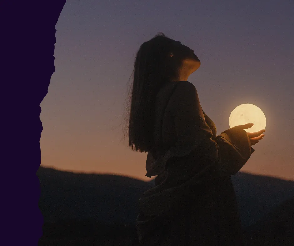 A woman in silhouette holding a glowing moon at sunset, representing the discovery of internal power and self-presence.