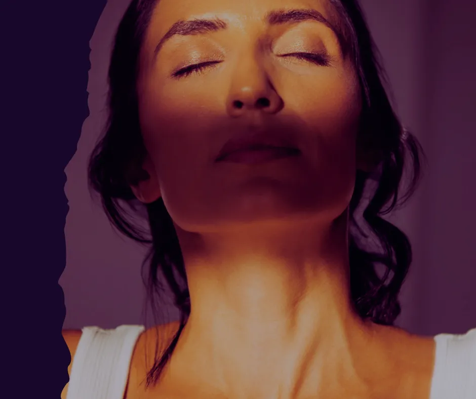 Woman in contemplative pose at dusk representing midlife transformation and self-discovery